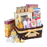 Baby gift hamper with feeding bottles, baby care products, diapers, and floral accents for delivery