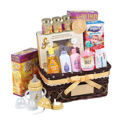 Baby gift hamper with feeding bottles, baby care products, diapers, and floral accents for delivery