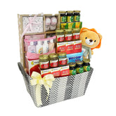 Baby gift hamper with soft toy, baby essentials, bird's nest bottles, and ribbon for flower delivery