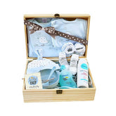 Baby clothing and bath essentials hamper in a wooden box, ideal for new baby flower delivery gift.