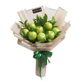 Fruit bouquet with green apples and leaves, wrapped for fresh flower delivery