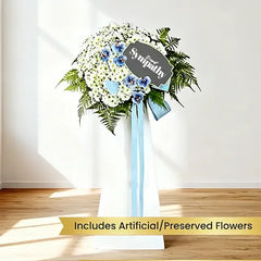 Sympathy floral stand with white and blue preserved flowers, ideal for flower delivery