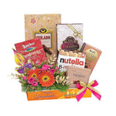 Flower delivery gift hamper with fresh flowers and assorted chocolates and treats