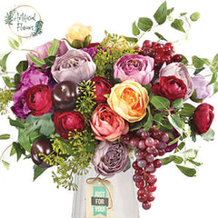Colorful artificial flower bouquet with roses and greenery in a vase for flower delivery