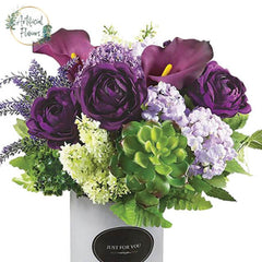 Purple artificial flower arrangement with green succulents for flower delivery