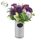 Artificial flower arrangement with purple roses and succulents in a vase for delivery