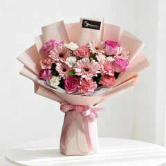 Pink and white bouquet with roses, carnations, and gerberas for same-day flower delivery