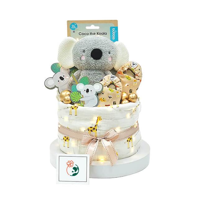 Baby gift hamper with soft koala toy, floral accents, giraffe wrap and glowing lights, ideal for delivery