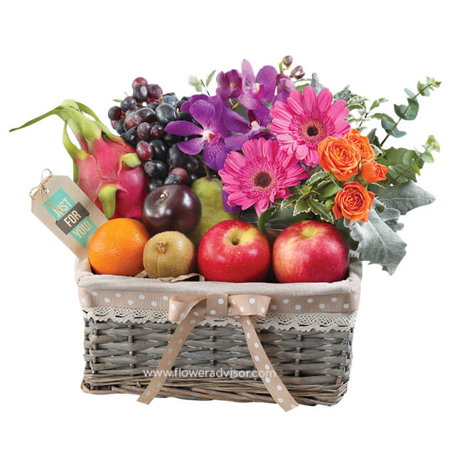 Fresh flower delivery basket with vibrant blooms and assorted fruits, perfect gift hamper