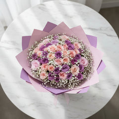 Purple and pink rose bouquet with baby’s breath for flower delivery