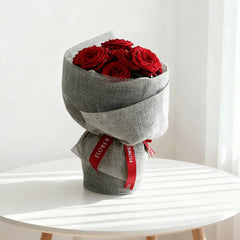 Bouquet of red roses in grey wrapping, perfect for flower delivery in Singapore