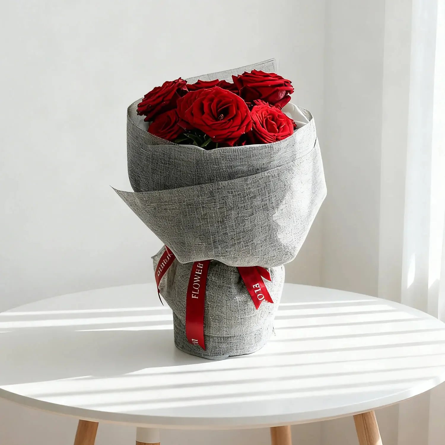 Bouquet of imported red roses wrapped in grey paper, perfect for flower delivery
