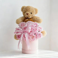 Pink roses with teddy bear in gift box for flower delivery