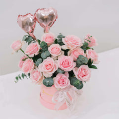 Pink rose bouquet with silver dollar eucalyptus and heart balloons for flower delivery
