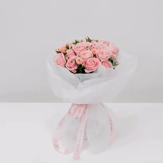 Elegant pink rose bouquet wrapped in white paper for flower delivery in Singapore