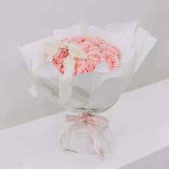 Elegant bouquet of pink roses with white wrapping, perfect for flower delivery gift
