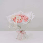 Elegant bouquet of pink roses with white wrapping, perfect for flower delivery in Singapore