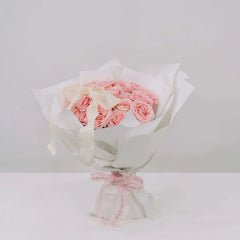 Elegant bouquet of pink roses with white wrapping, perfect for flower delivery in Singapore
