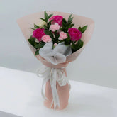 Pink and white rose bouquet with same-day flower delivery, wrapped in pink paper and ribbon