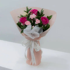 Pink and white rose bouquet with same-day flower delivery, wrapped in pink paper and ribbon