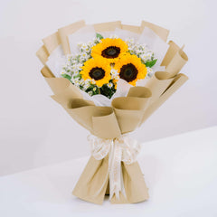 Sunflower bouquet with white fillers in kraft paper, ready for flower delivery in Singapore
