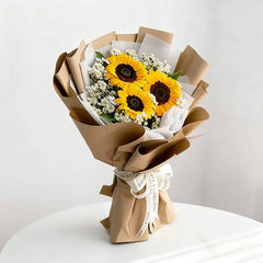 Sunflower and daisy bouquet wrapped in brown paper, perfect for flower delivery across Singapore