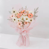 Bright pink and white gerbera daisy bouquet wrapped in pink for flower delivery