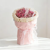 Pink baby's breath bouquet with white ribbon, ideal for flower delivery in Singapore