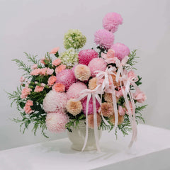 Elegant pink peony and mum flower arrangement with ribbons for flower delivery