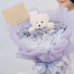 Purple baby’s breath bouquet with white teddy bear, ideal for flower delivery gift