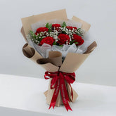 Red rose bouquet with baby's breath in brown wrapping, perfect for flower delivery in Singapore