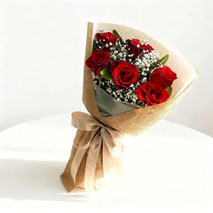 Red rose bouquet with baby's breath, wrapped in burlap for same-day flower delivery