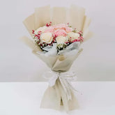 Elegant bouquet of white and pink roses with baby's breath, perfect for flower delivery.