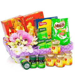 Wellness flower hamper with fresh gerbera daisies and gourmet treats for delivery