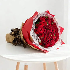 Elegant bouquet of red roses on a table, perfect for flower delivery in Singapore
