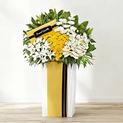 Sympathy flower stand arrangement with white and yellow blooms for delivery in Singapore