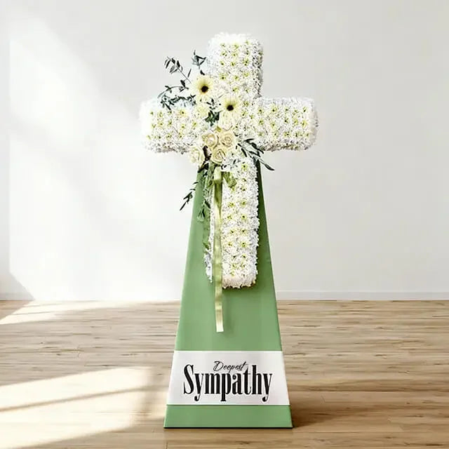 White floral cross funeral arrangement with sympathy message for flower delivery