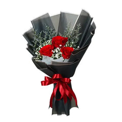 Red rose bouquet with greenery and black wrapping, ideal for flower delivery in Singapore