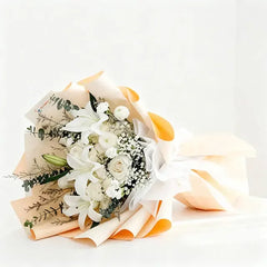 Elegant white lily and rose bouquet wrapped in peach paper, perfect for same-day flower delivery across Singapore