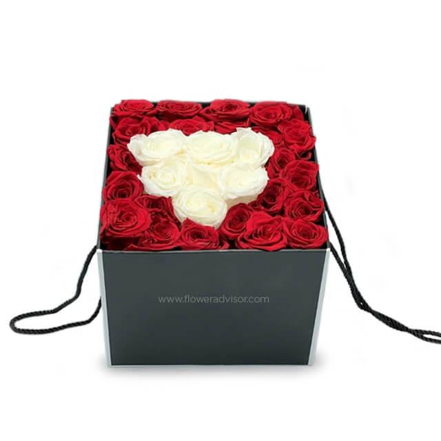Two-tone preserved roses in black square box for flower delivery, red and white heart shape
