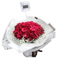 Large bouquet of 99 red roses with baby's breath, wrapped for flower delivery