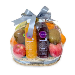 Gift basket with fresh tropical fruits and juice, ideal for flower delivery and gifting occasions