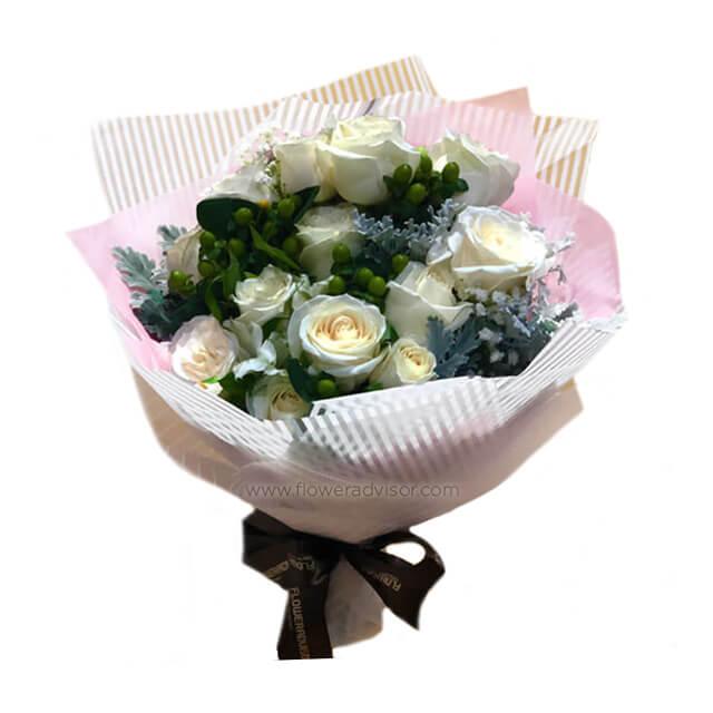 White rose bouquet with green hypericum berries, perfect for flower delivery in Singapore