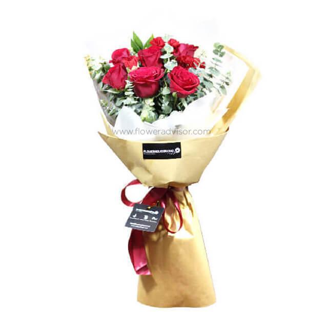 Bouquet of 15 red roses with statice, wrapped for flower delivery in Singapore