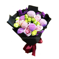 Pink rose and pom pom flower bouquet for flower delivery, wrapped in black paper with ribbon