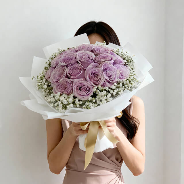 Bouquet of purple roses with baby's breath, ideal for Singapore flower delivery.