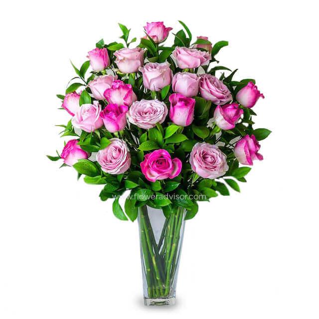 Lilac and two-tone pink rose bouquet in glass vase for flower delivery