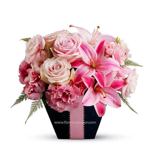 Pink lily and rose bouquet in black gift box for flower delivery