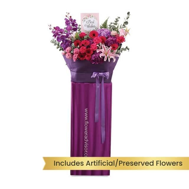 Grand opening flower stand with mixed preserved flowers in purple wrapping for delivery