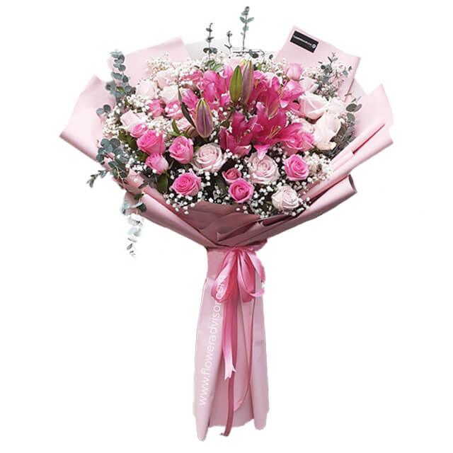 Hand bouquet of 40 pink roses and lilies, wrapped for flower delivery in Singapore